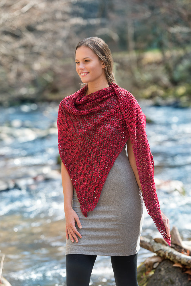 Woman wearing a large red lacy shawl.