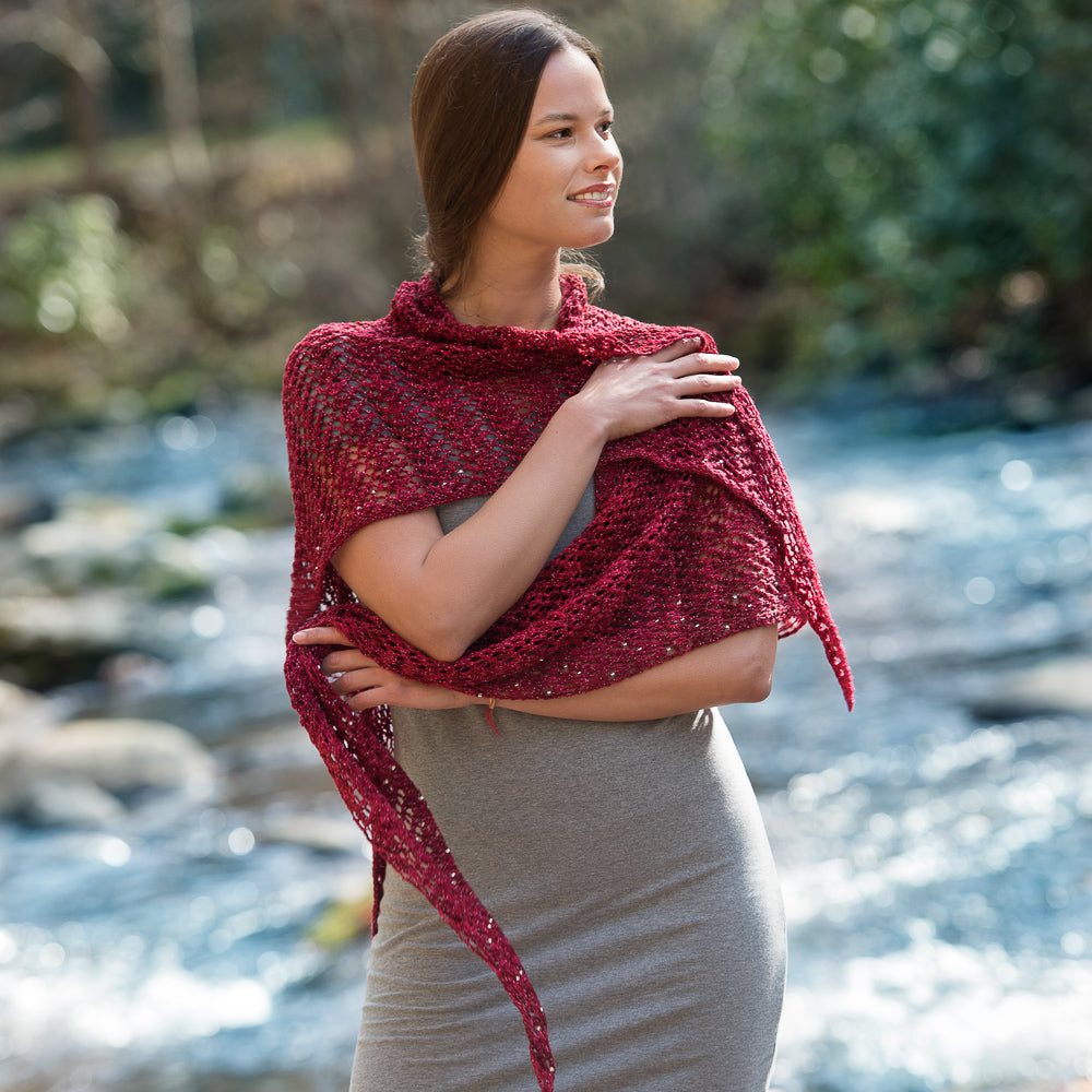 Woman wearing a large red lacy shawl.