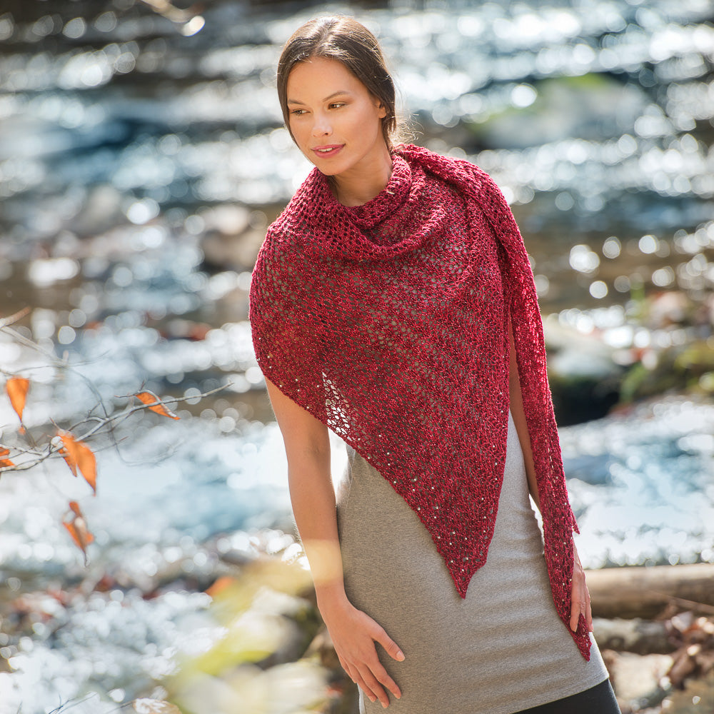 Woman wearing a large red lacy shawl.